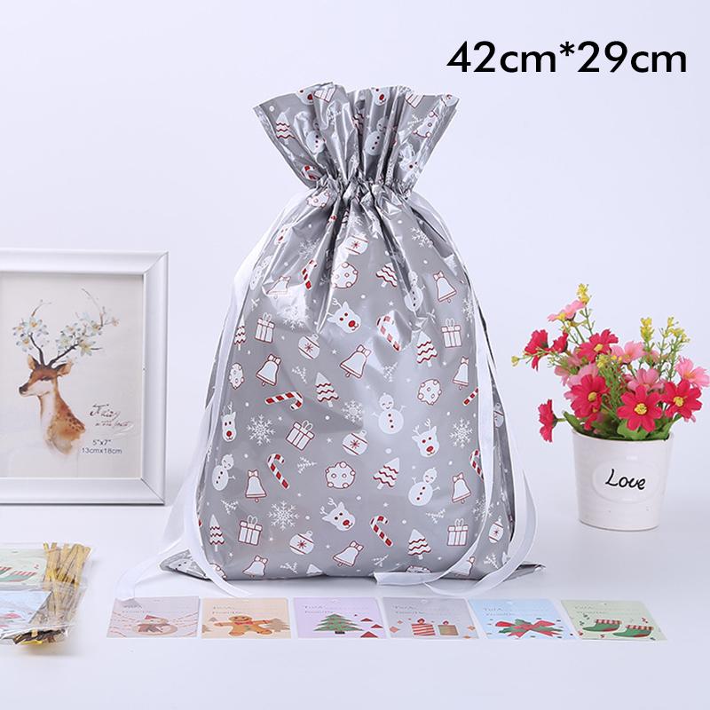 Stack of various sized festive drawstring gift bags in a holiday setting, ideal for Christmas gifts.