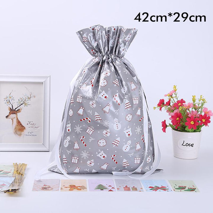 Stack of various sized festive drawstring gift bags in a holiday setting, ideal for Christmas gifts.