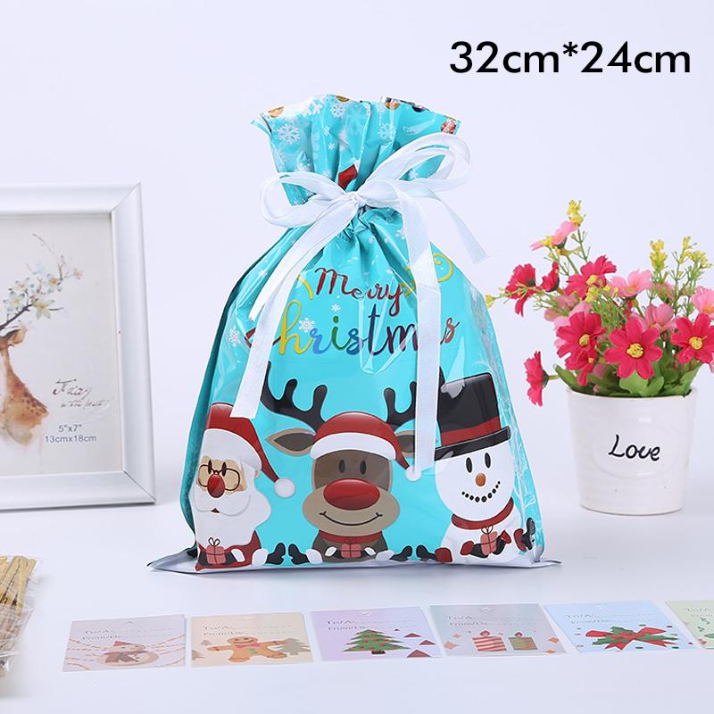 A person tying a green drawstring gift bag, showcasing its reusable and festive packaging design.