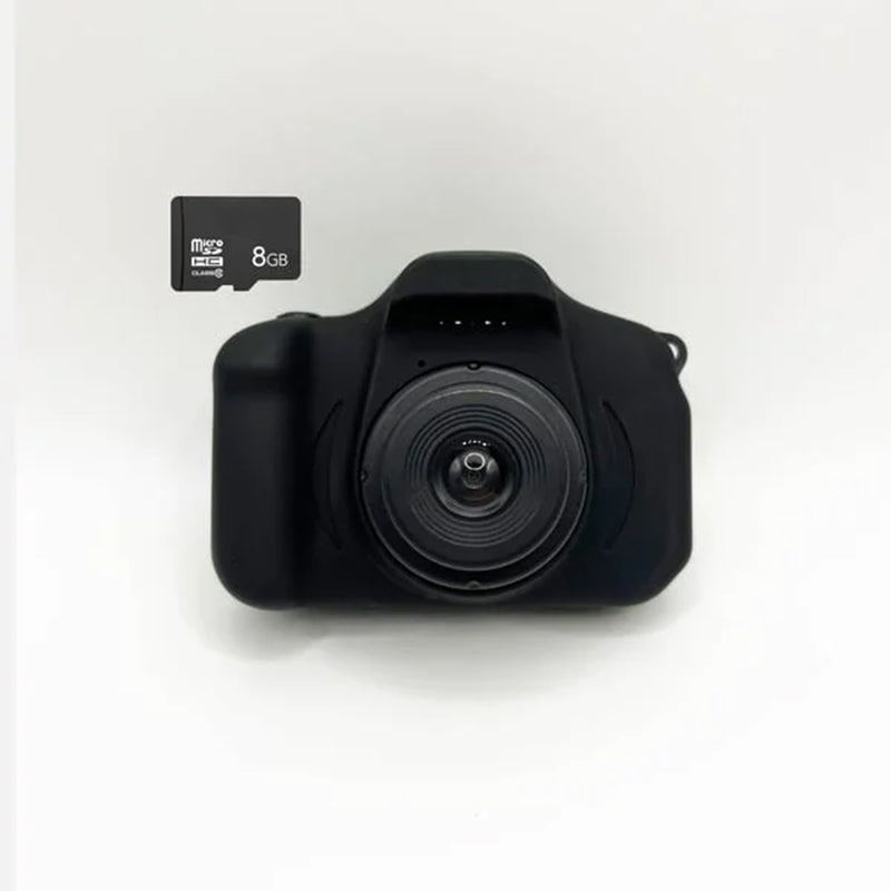 Toddler happily using a red kids' reusable mini digital camera, capturing a candid moment.