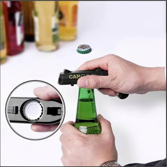 Hand holding a Novelty Cap Launcher Bottle Opener, demonstrating its ergonomic design.