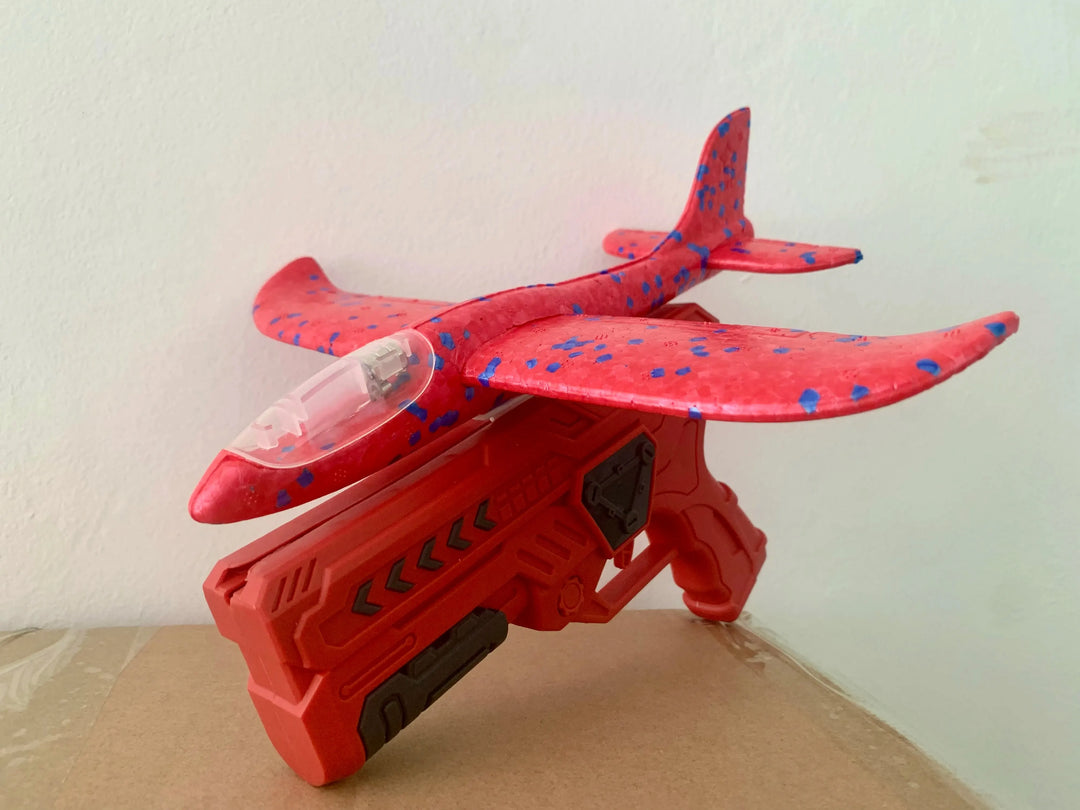 Durable red foam glider & launcher, glowing features for exciting outdoor play.
