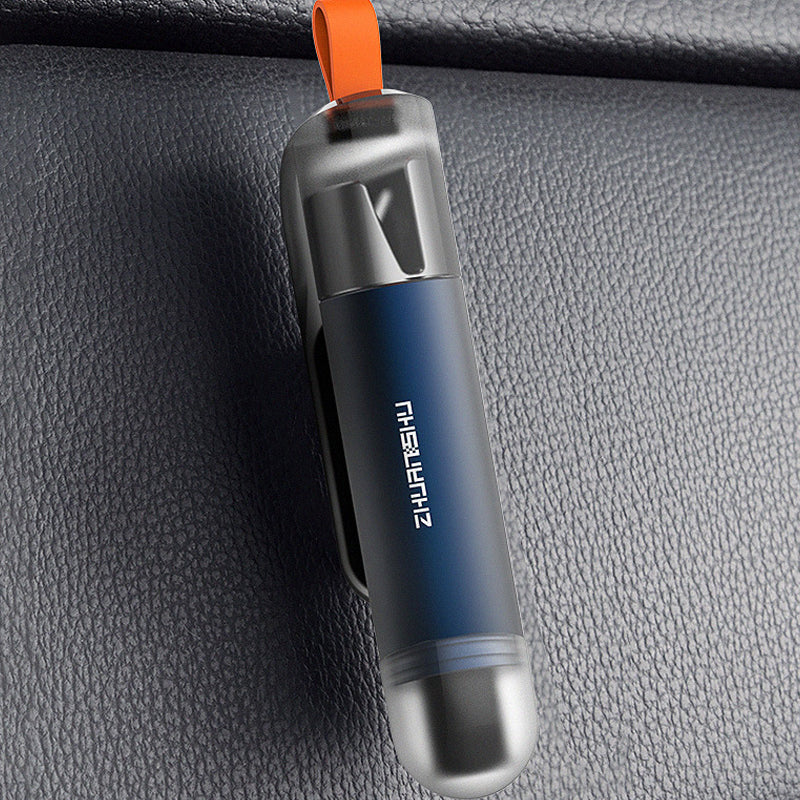 Universal vehicle emergency safety tool, shown next to a car seat belt, highlighting its cutting function