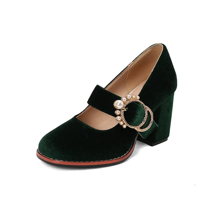 Collection of women's velvet pearl block heels in red, emerald green, and black.