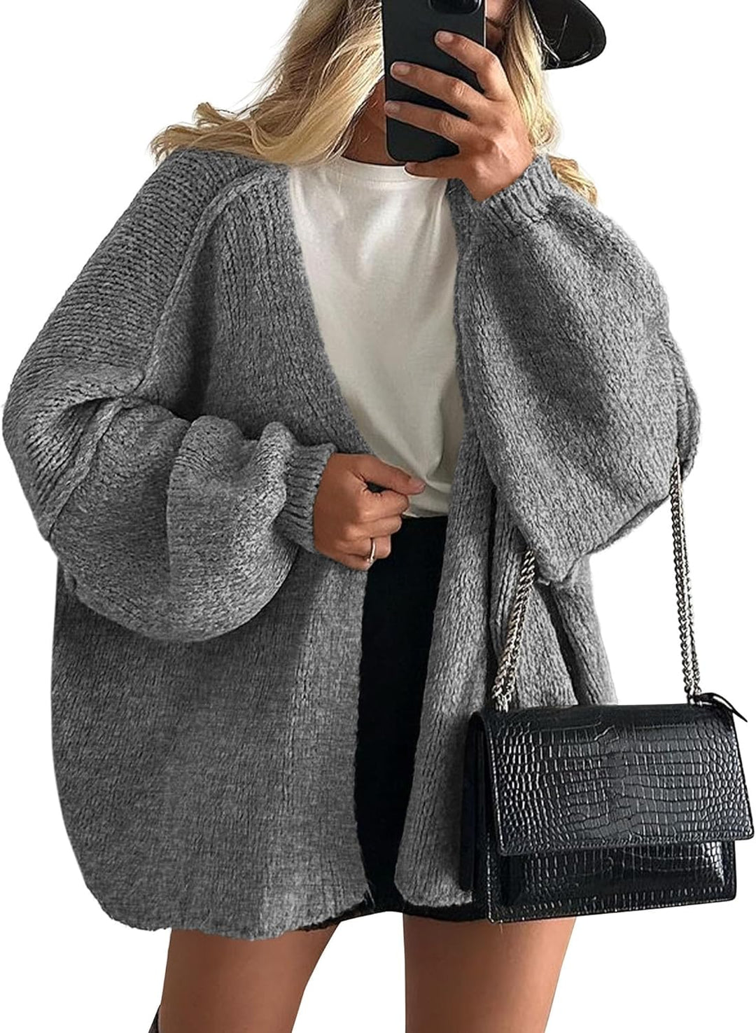 Model wearing a women's loose knit open front cardigan, styled for comfortable and chic layering.