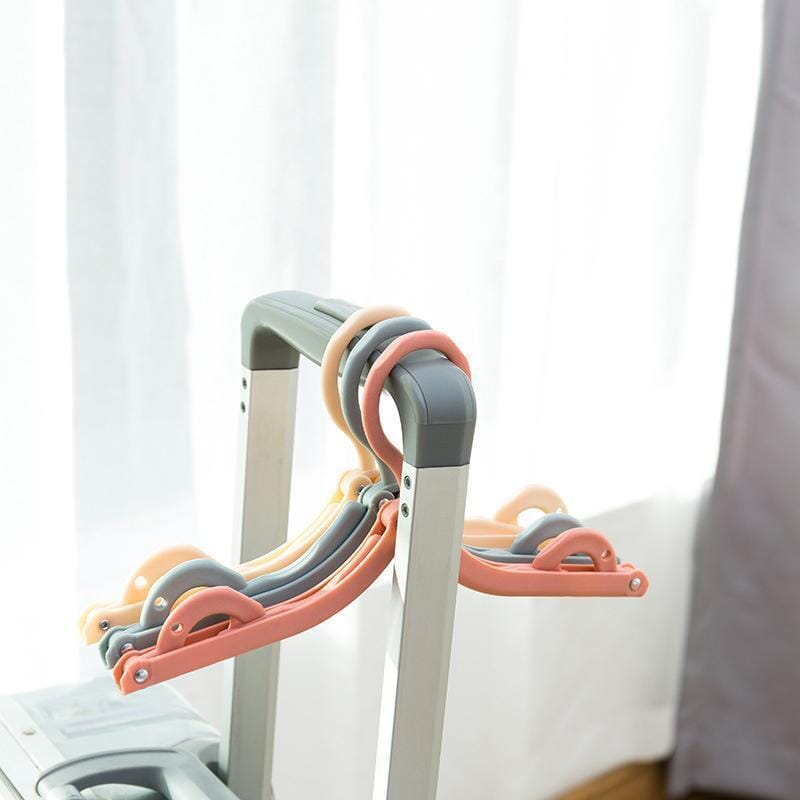 Folded portable travel hanger, demonstrating its compact size for easy storage and transport