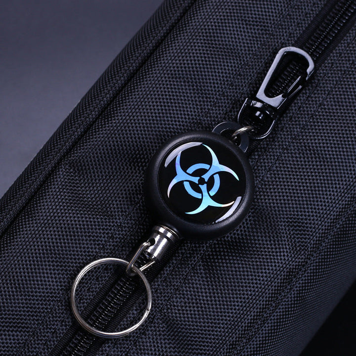 Convenient retractable key ring with a flexible wire cord, offered in a useful 3-piece set for security.