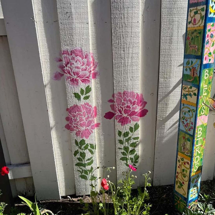 Person painting a wall with a reusable stencil from the DIY Decorative Stencil Set, homedecor