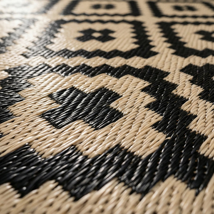 Stylish reversible boho outdoor rug with a flowing wave design, ideal for patio, deck, camping, and indoor-outdoor living.