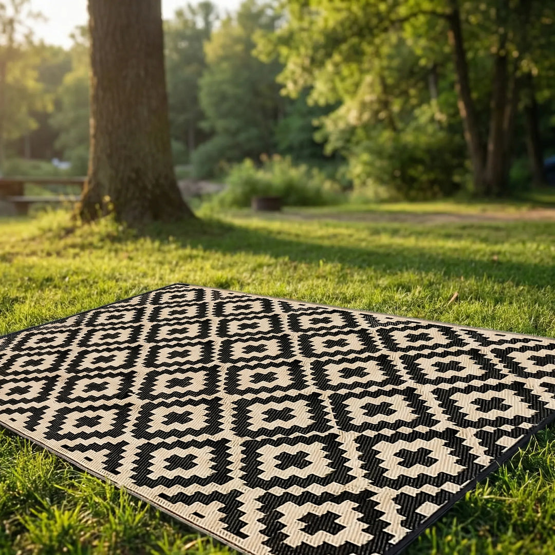Durable reversible outdoor area rug for patios & decks, featuring a modern boho wave pattern. Water-resistant & foldable.