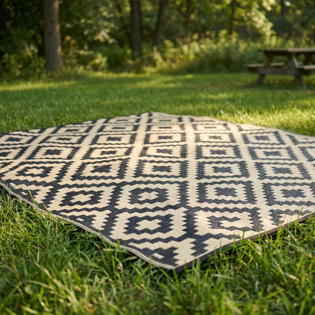 Geometric reversible boho outdoor rug with a captivating wave design. Enhances patio, deck, or camping areas. Water-resistant.