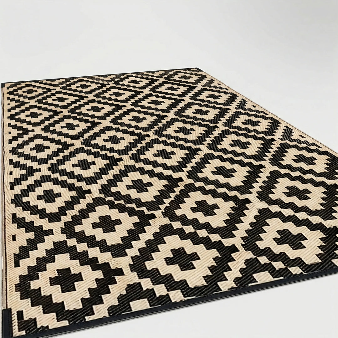Modern geometric outdoor patio rug with blue wave design. Reversible, weather-resistant & ideal for balconies.