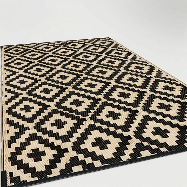 Modern geometric outdoor patio rug with blue wave design. Reversible, weather-resistant & ideal for balconies.