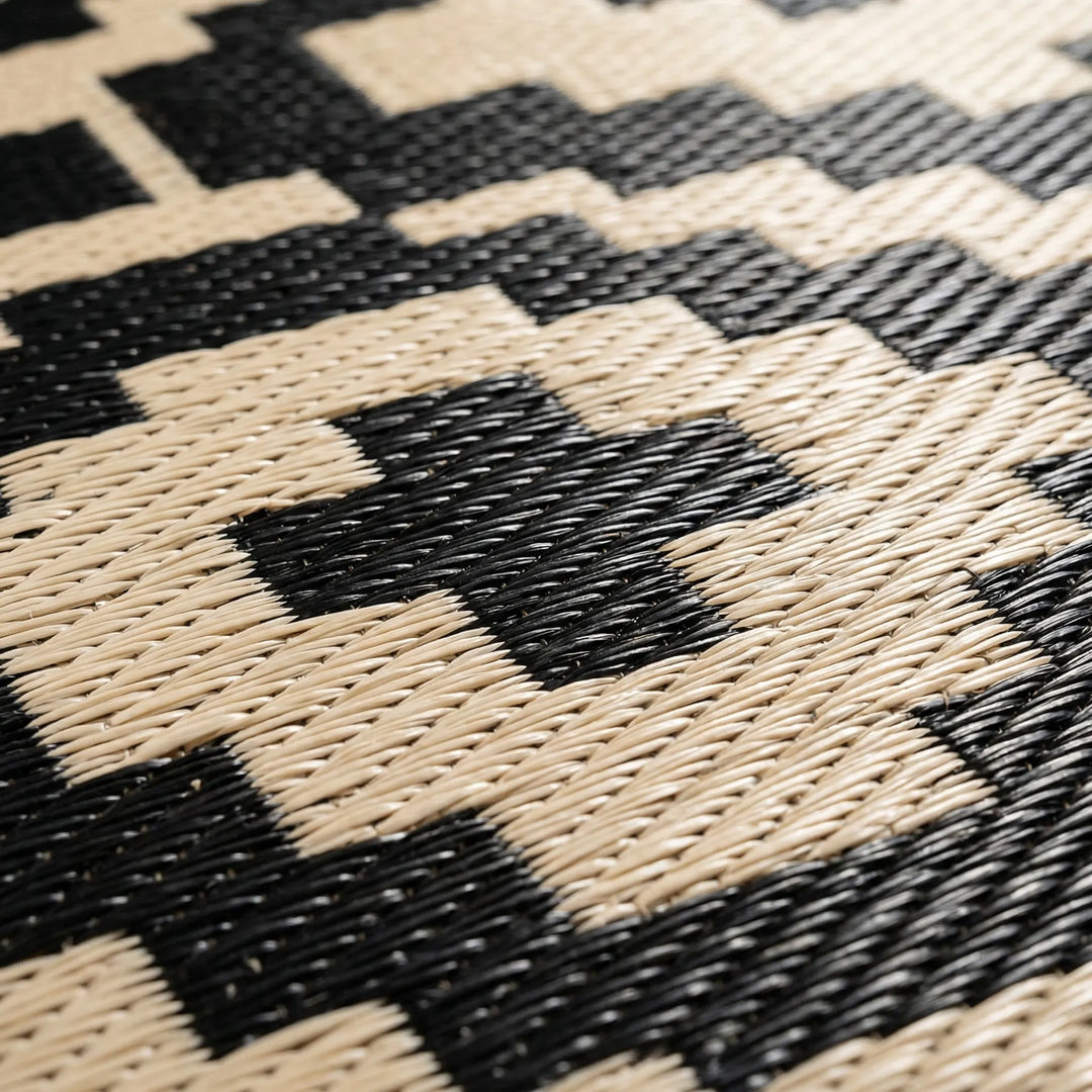 Easy-clean reversible outdoor geometric rug. Flowique wave pattern, weather-resistant for patio & balcony decor.