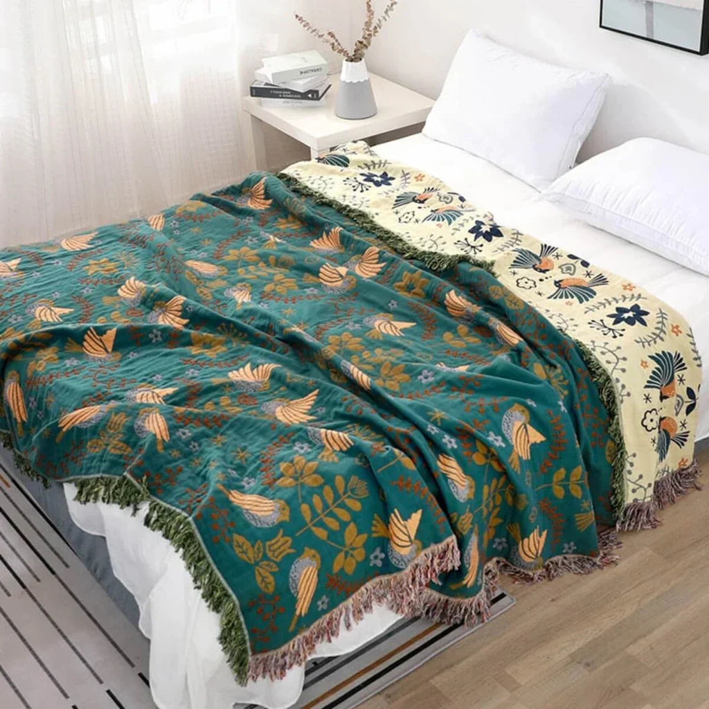 Reversible Scandinavian cotton throw blanket with modern bird & floral print for cozy home decor.