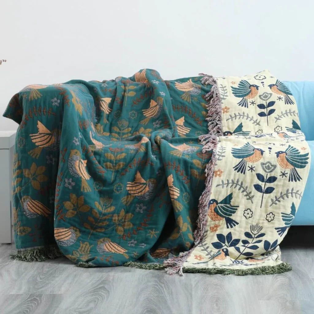 Soft, machine washable cotton blanket featuring a stylish Scandinavian bird design for ultimate coziness.