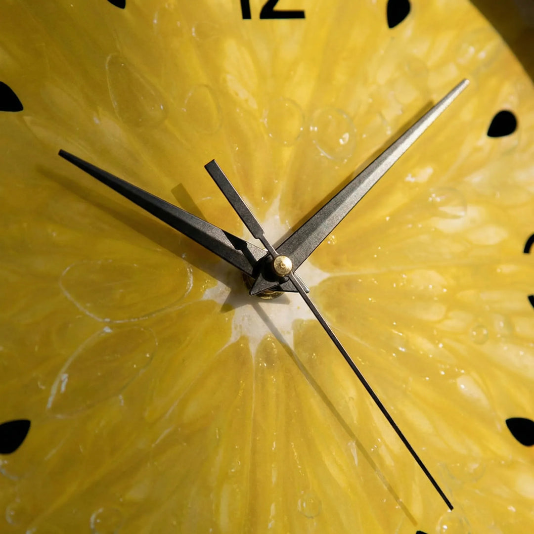 Modern round wall clock featuring a bright citrus fruit design, ideal decorative accent for kitchen home decor.