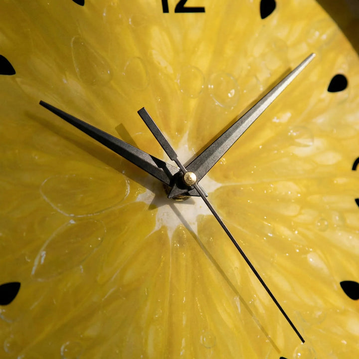 Modern round wall clock featuring a bright citrus fruit design, ideal decorative accent for kitchen home decor.