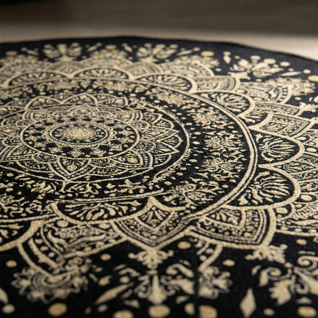Washable round mandala area rug for living rooms & bedrooms. Non-slip, decorative black & gold Flowique statement rug.
