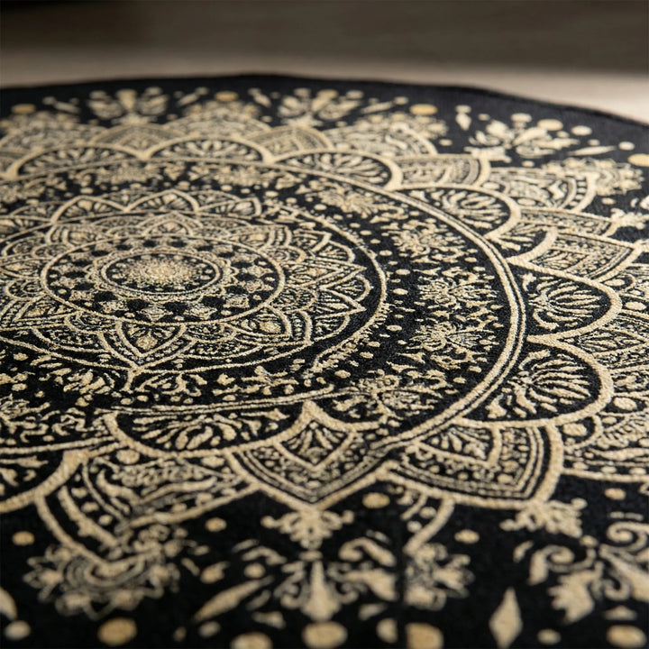 Washable round mandala area rug for living rooms & bedrooms. Non-slip, decorative black & gold Flowique statement rug.