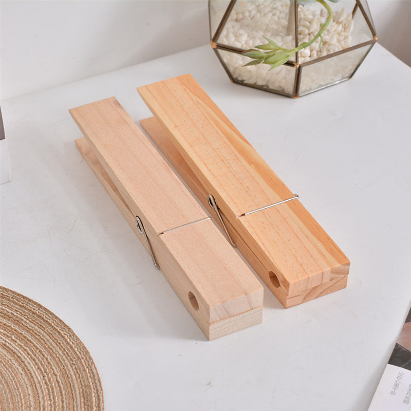 Rustic wooden towel holder with functional clothespin design, great for home organization.