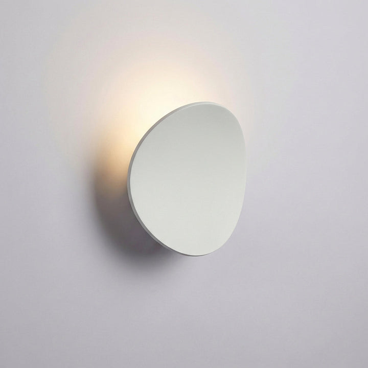 Hardwired Serevex LED wall sconce, with a clean minimalist design, creates beautiful ambient light for modern interiors.