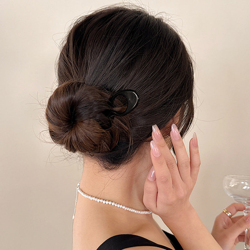 Hair pins scattered on a white surface, emphasizing their simplicity for women's hair styling.