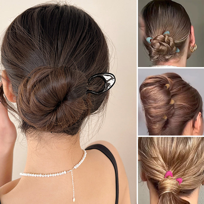 Close-up of a single black hair pin, showcasing its sleek design for women's updo hair styling.