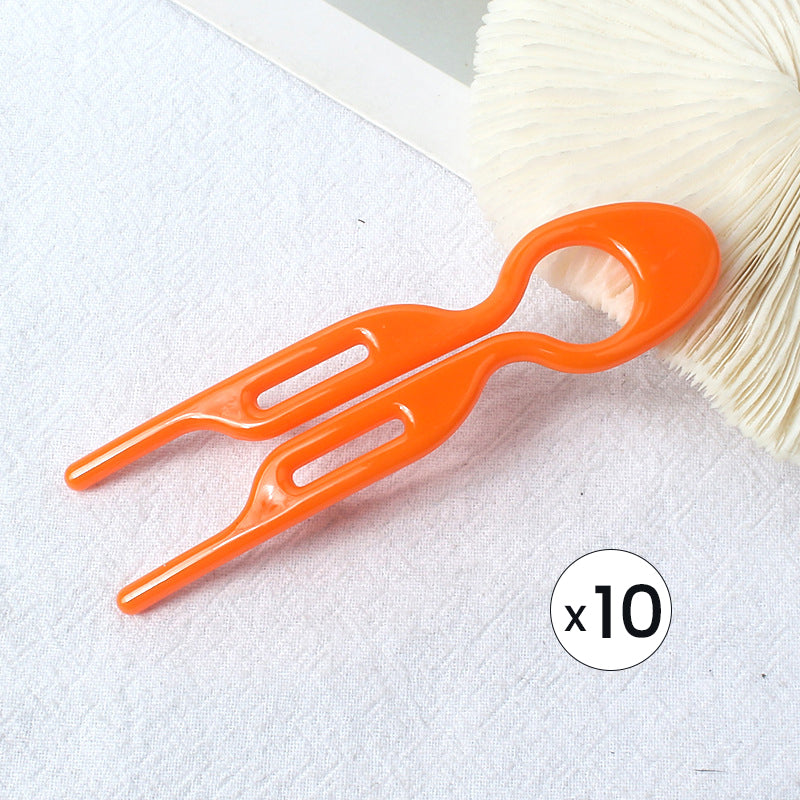 Casual updo held by black hair pins, ideal for everyday wear and a comfortable hair accessory.