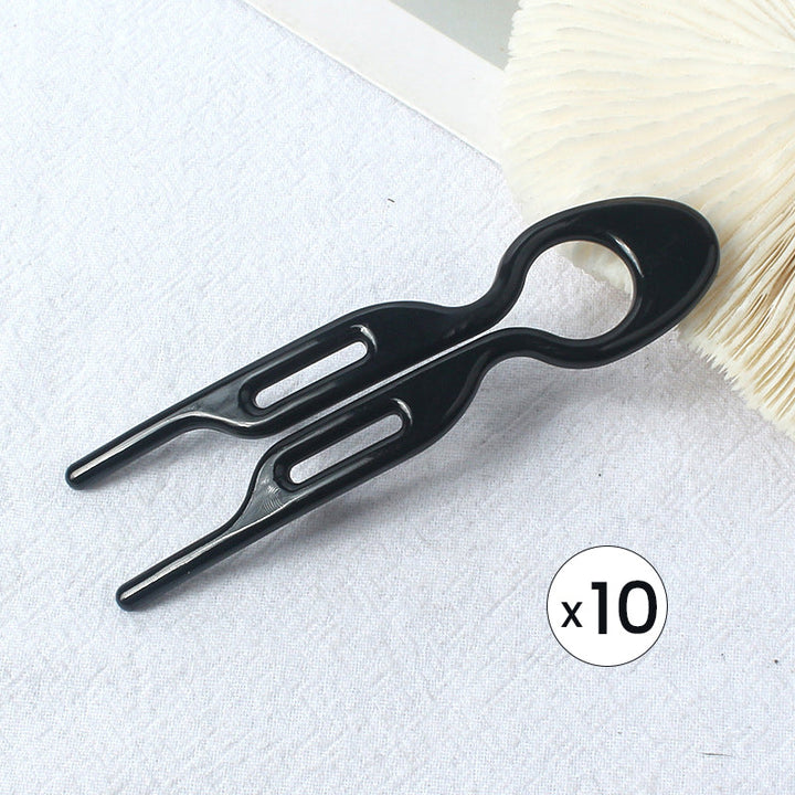 Close-up of the hair pin's smooth finish, designed to prevent hair damage during updo creation.