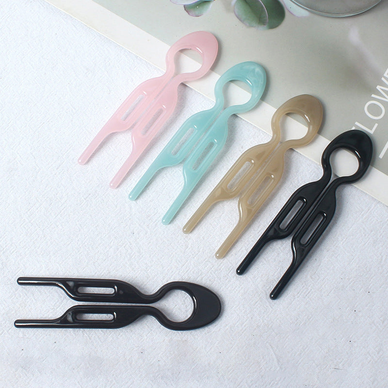 Black hair pins neatly arranged, highlighting them as essential women's hair accessories for updos.