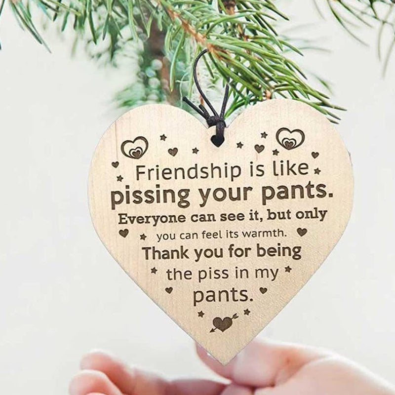 Hand-painted wooden Christmas tree ornamentation, celebrating friendship during holidays.