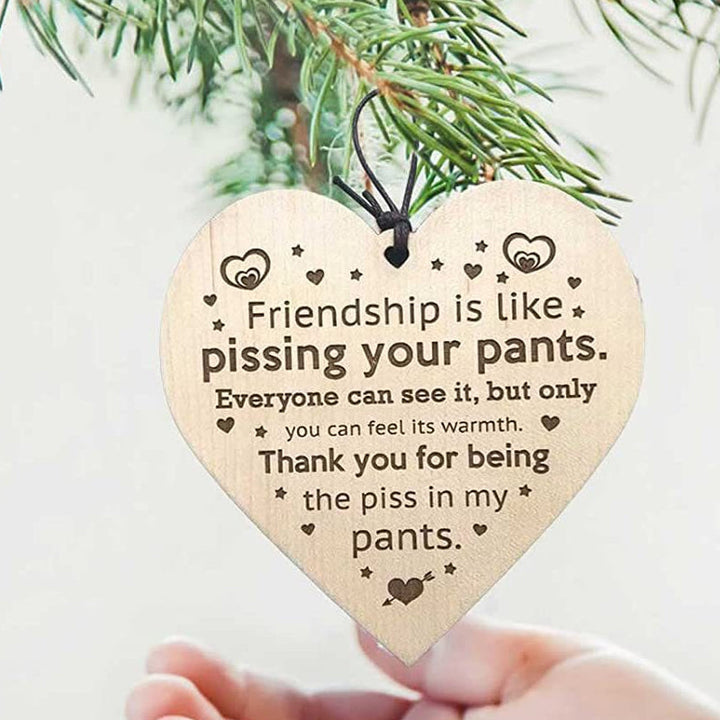 Hand-painted wooden Christmas tree ornamentation, celebrating friendship during holidays.