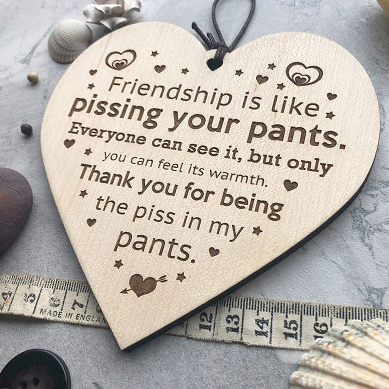 Detailed shot of a friendship-themed wooden Christmas ornament, festive home decor.