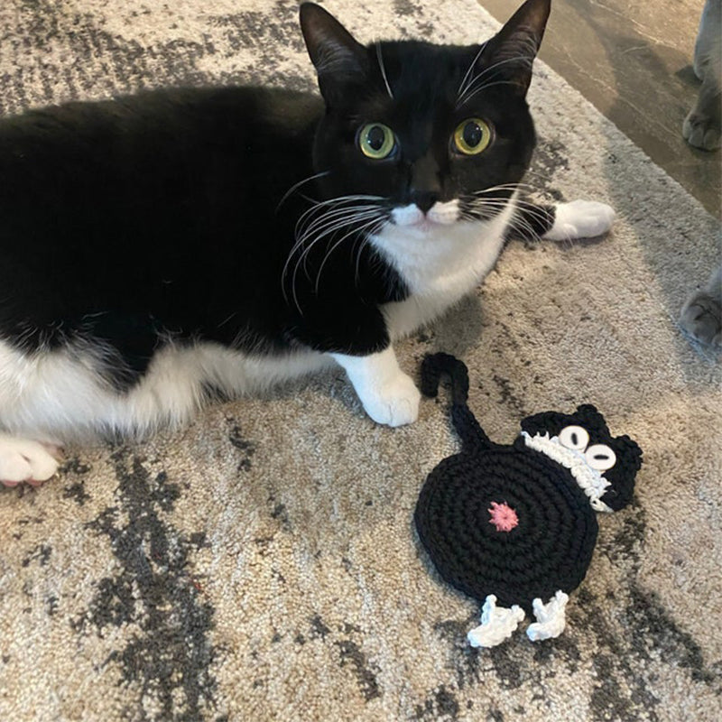 Close-up of a black and white cat butt coaster; unique drinkware gift for cat owners.