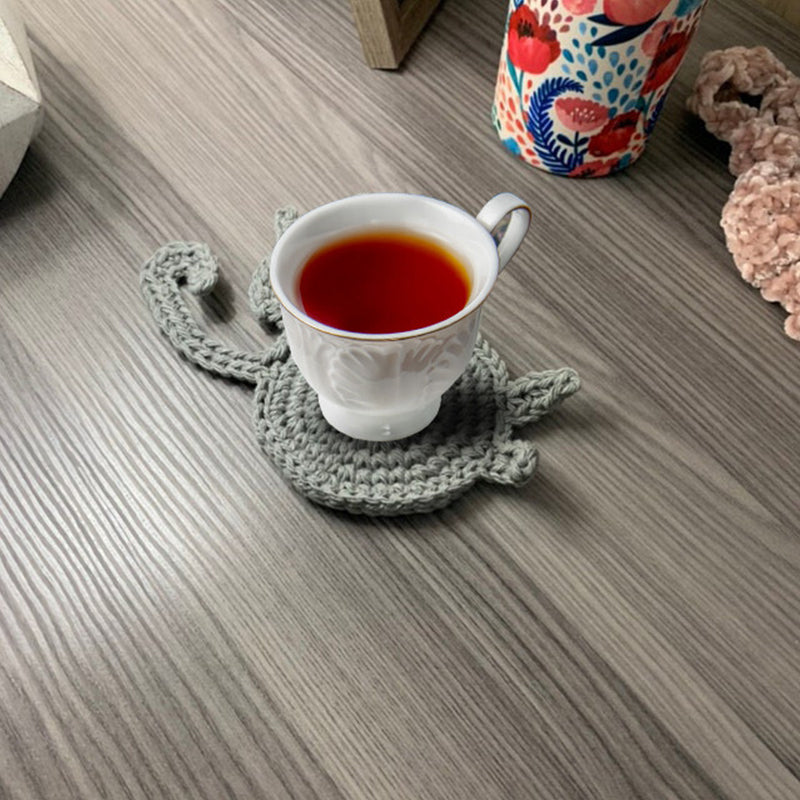 Handmade cotton cat butt coaster, a humorous and unique gift for drinkware enthusiasts.