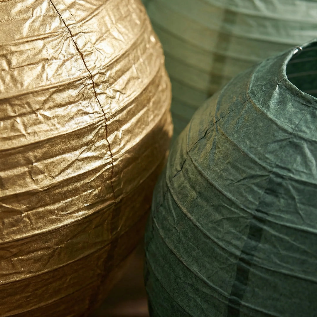 Stylish decorative round hanging lanterns, a mixed-size set for unique home decor and festive event ambiance.