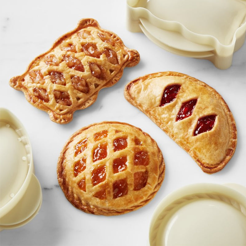 Set of mini pie molds for baking individual-sized fruit tarts and savory pocket snacks, ideal for home baking