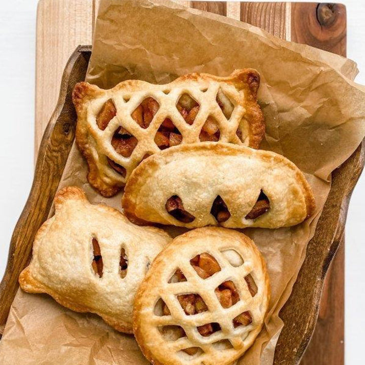 Mini hand pie mold with a baked apple pie inside, showcasing the perfect crimped edge on a golden pastry