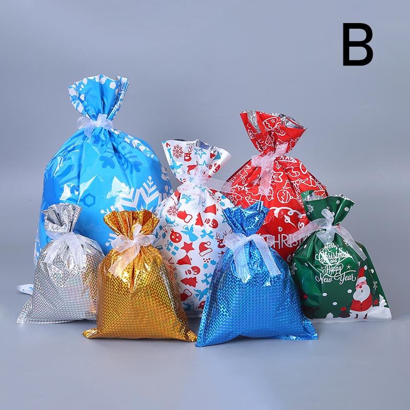 Child's hand placing a present into a red reusable Christmas drawstring gift bag, eco-friendly holiday wrapping