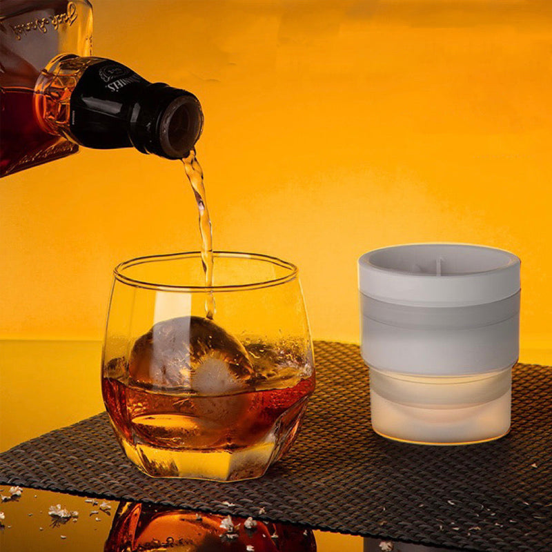 Ice ball mold separated, showing the two halves open, ready for easy ice sphere removal for cocktails.