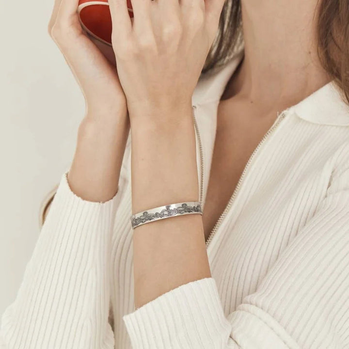 Close-up of the engraved 'Granddaughter' message on a stainless steel cuff bracelet