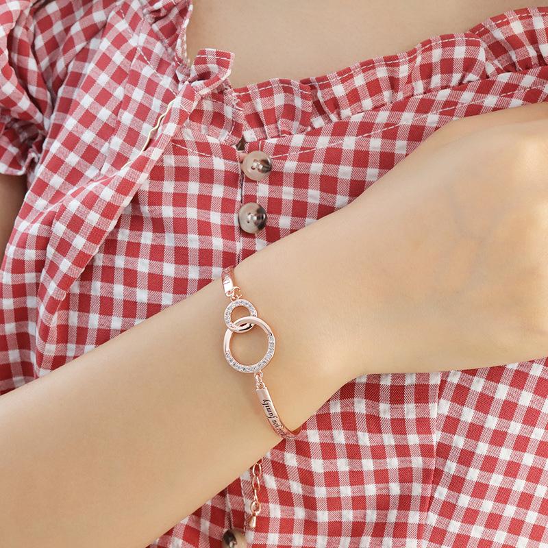 Two women's adjustable friendship bracelets, one silver, one gold, showcasing best friend gift options.