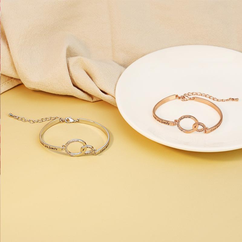 Adjustable golden charm bracelet on a wrist, highlighting its comfortable fit and inspirational design.