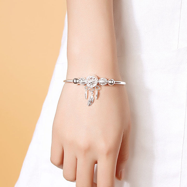 Womens silver charm bracelet featuring a beautiful dreamcatcher, adjustable, presented in a gift box