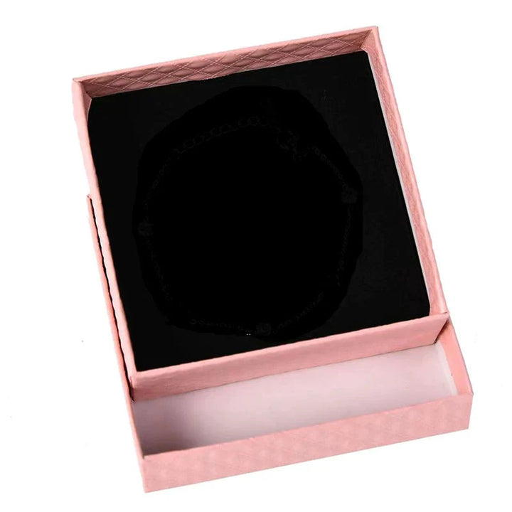 Detailed view of women's adjustable silver dreamcatcher bracelet and accompanying gift box