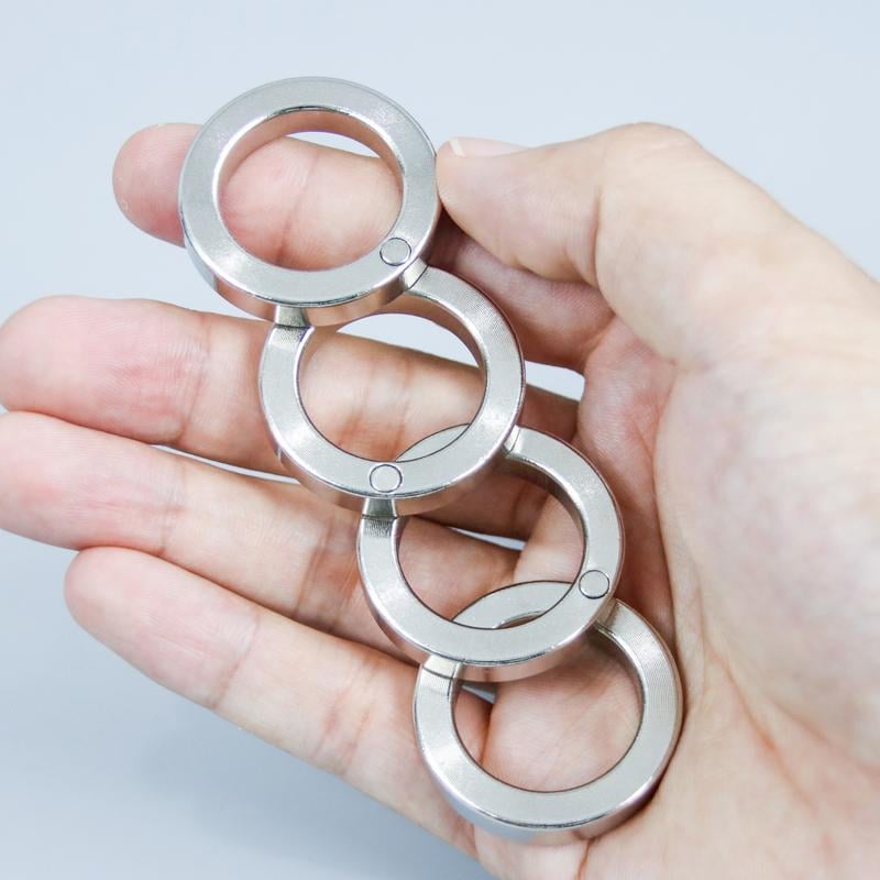 Discrete metallic folding fidget ring, a portable tactile tool for stress relief and on-the-go focus.
