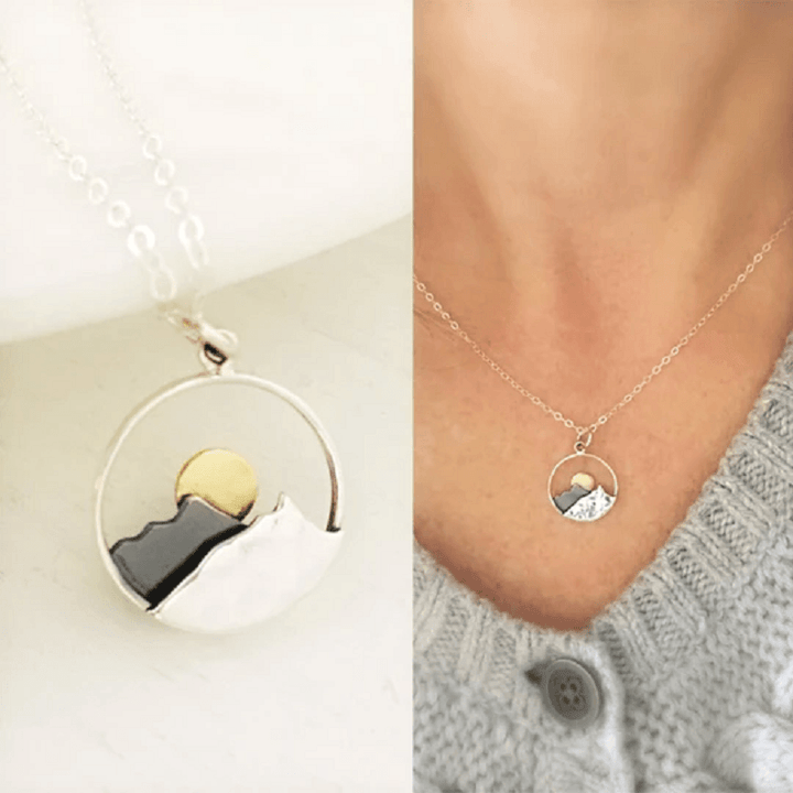 Couple's silver mountain range necklace, representing outdoor adventure and natural beauty.