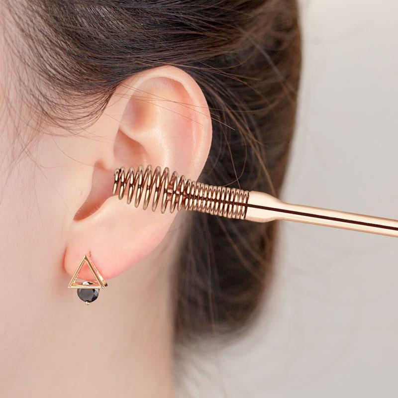Close-up of a 6-piece rose gold stainless steel earwax removal tool set for hygiene.