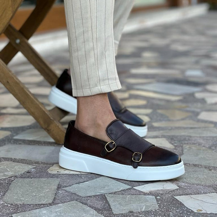 Comfortable men's slip-on buckle sneakers in black leather, perfect for versatile everyday walking & style.